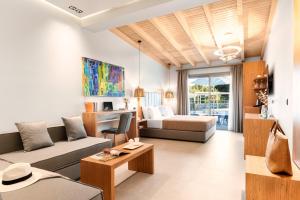 a living room with a couch and a bed at Chrousso Village in Paliouri