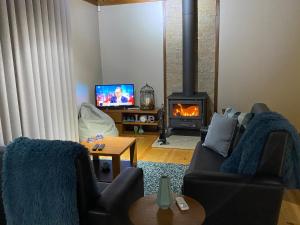 a living room with a couch and a fireplace at Refúgio de Gestaças in Vieira do Minho