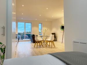 a bedroom with a table and chairs in a room at Fleets Height Apartment Nine in Fleet