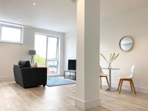 a living room with a couch and a table at Fleet Heights Apartment Eight in Fleet