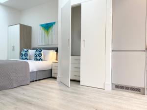 a bedroom with a bed and a white closet at Horizon at Fleet Heights Apartment Eight in Fleet +16 photos