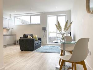 a living room with a table and a couch at Horizon at Fleet Heights Apartment Eight in Fleet