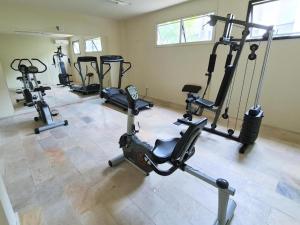a gym with several tread machines in a room at Flat TOP - No Praia Brava Hotel na ilha a beira mar in Florianópolis