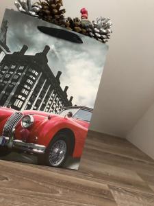 a picture of a red car on a wall at Serban Home Arenele Romane Marius Nasta in Bucharest