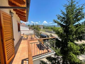 a balcony of a house with a table and a tree at Ca l’Albert - Casa rural acollidora in Isona