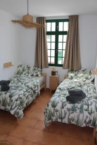 Łóżko lub łóżka w pokoju w obiekcie Casa La Esperanza