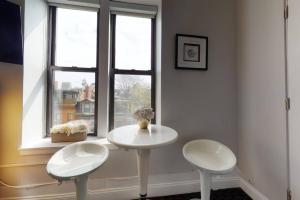 a white table and two chairs in front of a window at Charming Studio in Boston Brownstone, #44 in Boston