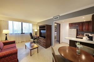 a living room with a couch a table and a kitchen at Crowne Plaza Panama, an IHG Hotel in Panama City