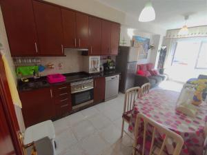 a kitchen with a table and a dining room at Apartamento Paseo del Puerto in Finisterre