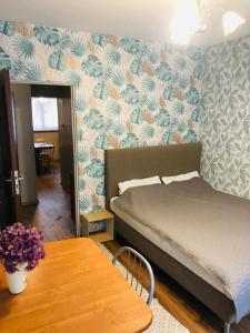 a bedroom with a bed and a wooden table at Apartament Gosia in Rogowo