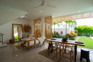 a living room with a table and a chair at Villa Diola 1 in Canggu