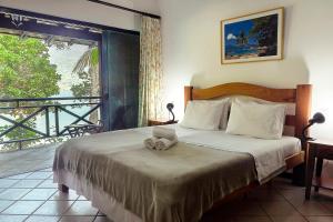 a bedroom with a bed with two stuffed animals on it at Pousada Portal do Sol in Abraão +69 photos