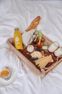 a tray of food with a sandwich and a bottle of juice at Edgar Guesthouse in Ghent