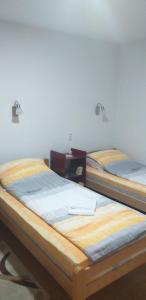two beds sitting next to each other in a room at Joca in Bajina Bašta