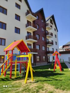 a playground in front of a apartment building at Apartments Mons in Vila Katalina in Zlatibor