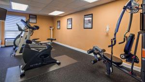 a gym with several tread machines in a room at Best Western Galaxy Inn in Dover