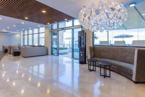 a lobby with a couch and a chandelier at Radisson Blu Resort Gran Canaria in La Playa de Arguineguín +37 photos