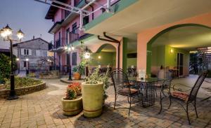 a patio with a table and chairs in a building at La Villa - Sure Hotel Collection by Best Western in Ivrea