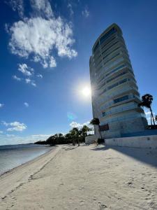 a building on a beach next to the water at Ocean front apartment in Cancun in Cancún