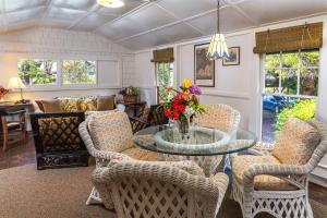 a living room with a glass table and chairs at Volcano Village Estates in Volcano