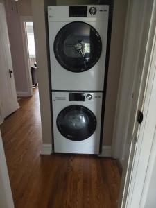 a washer and dryer sitting in a room at Elcho explOre Ottawa in Ottawa