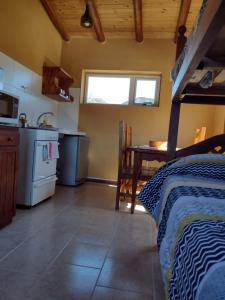 a room with a kitchen and a bed in a room at Paso del Cuadrado in El Chalten