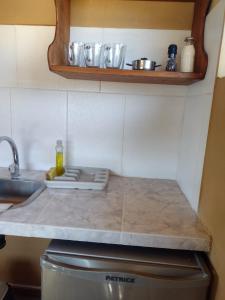 a kitchen with a counter top with a sink and a counter top at Paso del Cuadrado in El Chalten