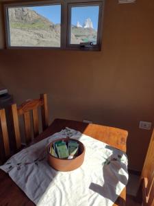 a bowl on a table in a room with two windows at Paso del Cuadrado in El Chalten