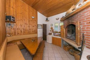 a kitchen with a wooden table and a brick wall at Villa Leo in Jesenice