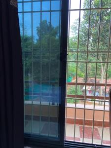 a view of a swimming pool through a window at Erisha Tadoba in Mohurli