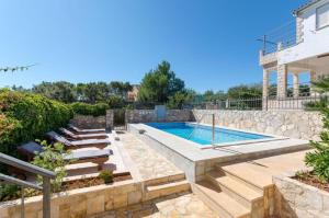 a swimming pool in a yard with a house at Apartment Lucija - with Pool in Rogač