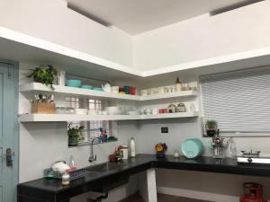 a kitchen with a sink and a counter top at Bodhi garden villa in varkala in Varkala