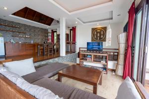 a living room with a couch and a table at Eagles Nest Villa in Ko Lanta