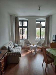 a living room with a couch and a table at City Apartments Magdeburg in Magdeburg