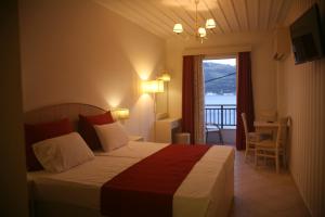Postel nebo postele na pokoji v ubytování Mirini Hotel