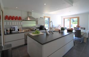a kitchen with a large island in a kitchen at La Balade des Marais in Saint-Molf
