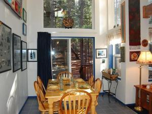 a dining room with a wooden table and chairs at Bear Crossing in Wawona