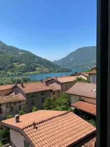 a view of a town with a river and mountains at La corte dell'orologio in Endine Gaiano