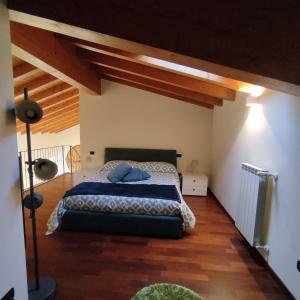 a bedroom with a bed with blue pillows on it at La corte dell'orologio in Endine Gaiano