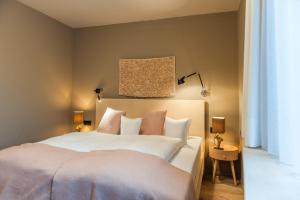 Postel nebo postele na pokoji v ubytování Arlsuites