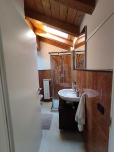 a bathroom with a sink and a shower at La corte dell'orologio in Endine Gaiano +56 photos