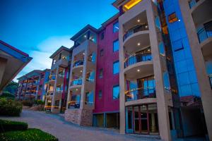 a row of tall apartment buildings at dusk at Bon Bini Residence in Kampala