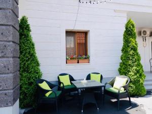 a table and chairs in front of a building at Grand Fortune Hotel in Yerevan