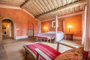 a bedroom with a bed and a couch in a room at Lavacchio 10 by Salogi Villas in Montalcino +37 photos