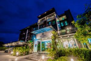 aominium building with lights on at night at The Living Hotel SamutPrakan in Bang Bo