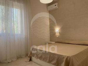 a bedroom with a bed and a large window at Villa Sebastia - 100m dalla spiaggia By Cala Salento in Torre Lapillo