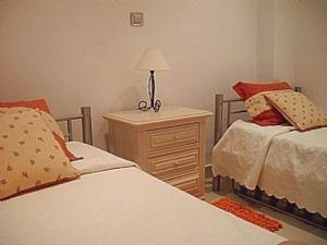 a bedroom with two beds and a lamp on a night stand at Modern 2 Bed Apartment Vale do Lobo in Vale do Lobo +25 photos