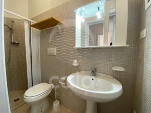 a bathroom with a sink and a toilet and a mirror at Villa Stella La tina - Spiaggia a 300m By Cala Salento in Torre Lapillo +28 photos