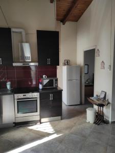 a kitchen with a stove and a refrigerator at Near AirportAnd metropolitan Penelopi Cozy Home in Artemida +8 photos