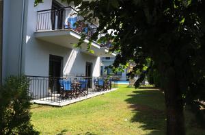 a building with chairs and tables on a balcony at Aliston Hotel Thassos in Skala Potamias